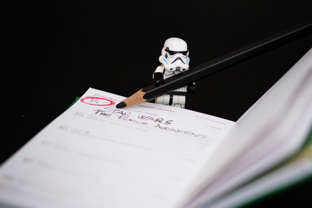 person writing down on a notebook